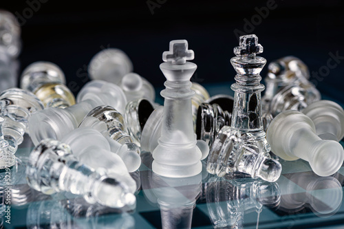 glass chess board game in black background ,selective focus on King, leadership concept