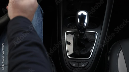 The hand switches the speed on the automatic transmission to the neutral position Close-up
