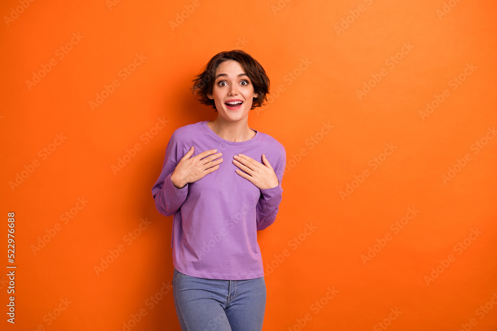 Obraz premium Photo of charming impressed lady wear violet sweatshirt arms chest empty space isolated orange color background