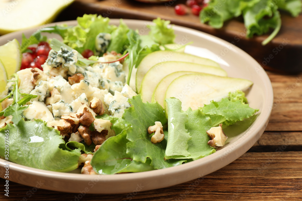 Fresh salad with pear on wooden table Fresh salad with pear on wooden table