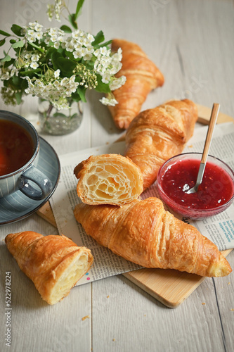 Closeup Table with baked croissant and tea photo