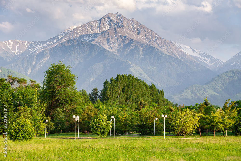 a favorite resting place of Almaty residents in the park of the first president against the backdrop of the Tien Shan mountains. Summer time. Big Almaty Peak