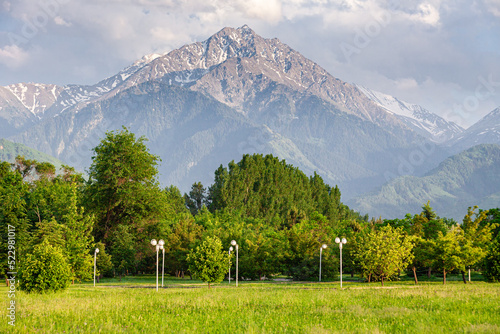 Obraz na płótnie a favorite resting place of Almaty residents in the park of the first president against the backdrop of the Tien Shan mountains. Summer time. Big Almaty Peak w salonie