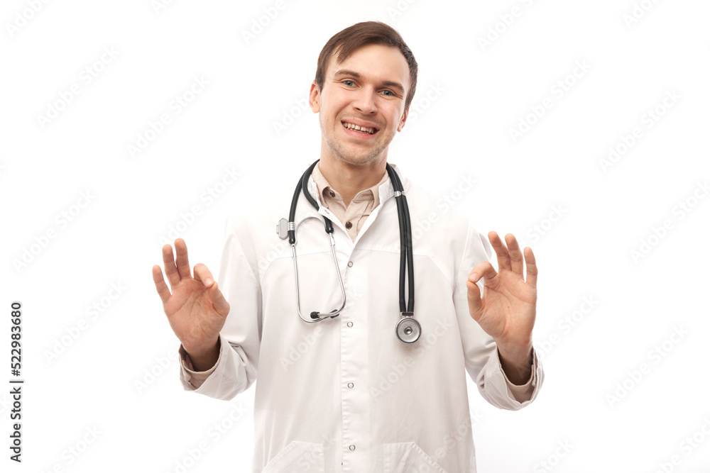 Portrait of happy doctor in white medical coat showing gesture all is well isolated on white background with copy space Portrait of happy doctor in white medical coat showing gesture all is well isolated on white background with copy space