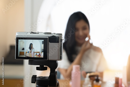 Young beautiful Asian woman and professional beauty make up artist vlogger or blogger recording makeup tutorial to share on website or social media. Business online influencer on social media concept