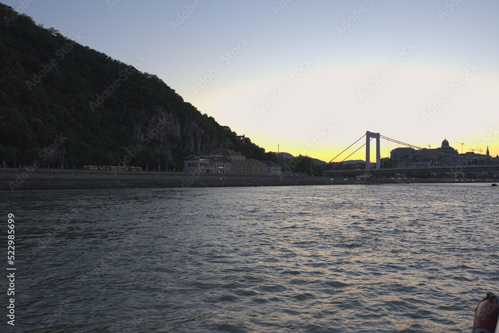 River, hill and bridge at dusk