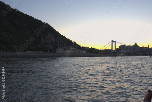 Obraz na płótnie River, hill and bridge at dusk w salonie
