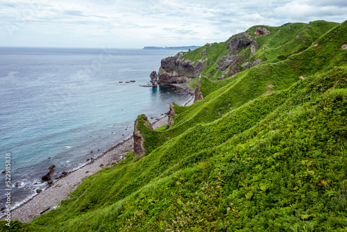 A steep cape surrounded by greenery in Hokkaido Japan