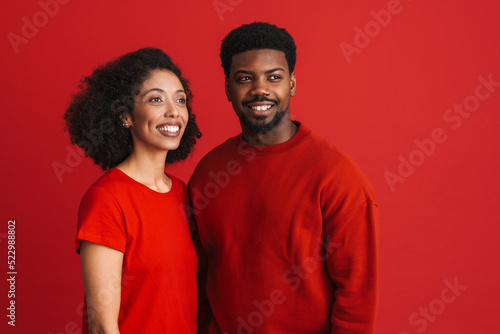 Black happy man and woman smiling and looking at copyspace