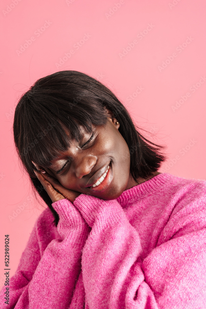 Portrait of young beautiful smiling african woman showing sleeping gesture Portrait of young beautiful smiling african woman showing sleeping gesture