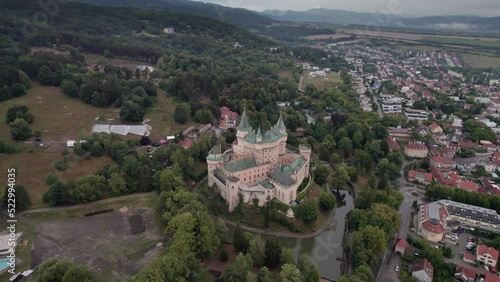 Aerial orbit movement around Bojnice Castle of the Spirits in Slovakia. European Romantic fairytale castle built in the 12th century with gothic and rennaissance architecture. photo