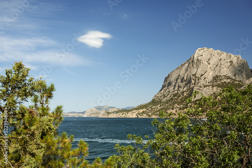 Scenic landscape of blue sea  mountains and green trees. Beautiful summer nature of Crimea. The village of Novy Svet.