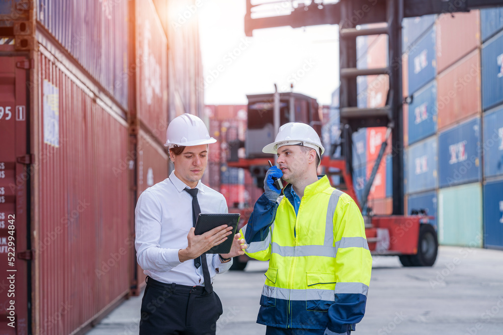 Manager and worker working checking stock into container for loading,Logistic and business export. Manager and worker working checking stock into container for loading,Logistic and business export.