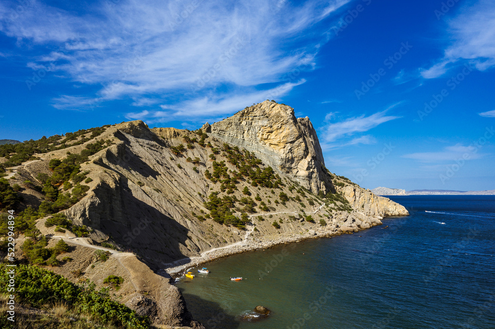 Beautiful summer nature of Crimea. The village of Novy Svet. The Golitsyn Trail. Black sea. Huge rock mountain.