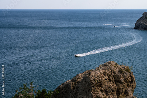 Beautiful landscape of Crimea nature. Rocky mountains in the Black sea. Pleasure boats.
