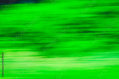 Abstract Green trees motion blurred green leaves background.