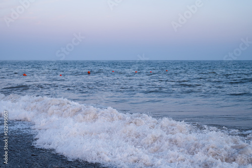 Scenic landscape of pebbled beach and Black sea at twilight.