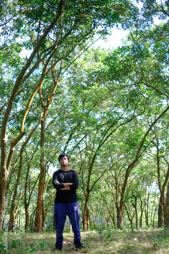 South asian young boy relaxing in a natural rubber forest