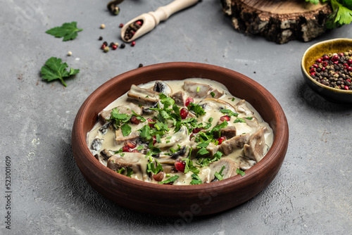Slow cooked pork stew with mushrooms in creamy sauce served with parsley. Restaurant menu, dieting, cookbook recipe top view