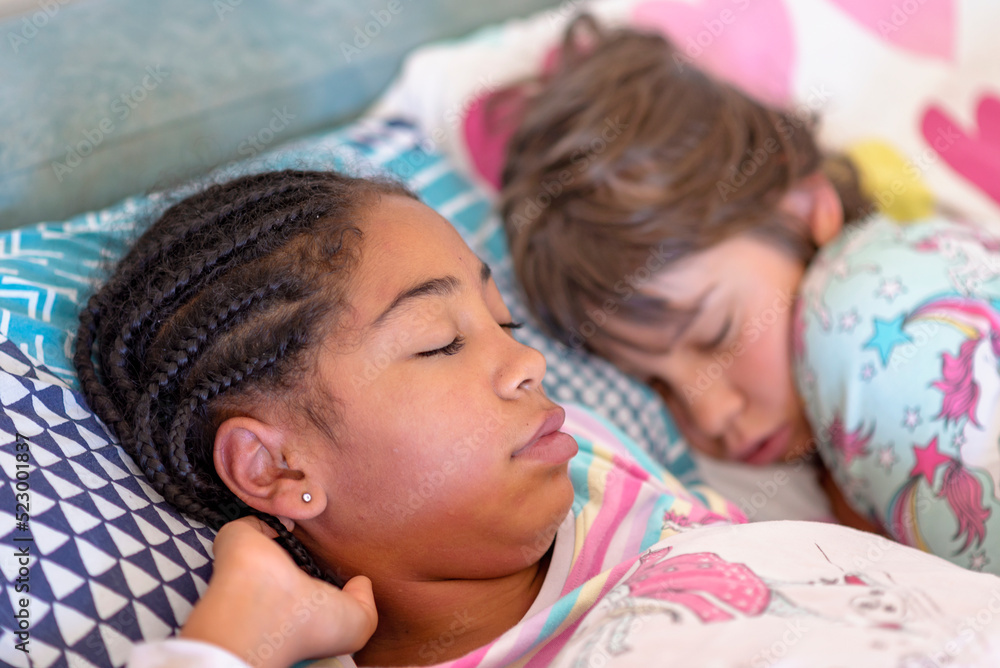 two girls sleeping together, multi racial friendship, black and white