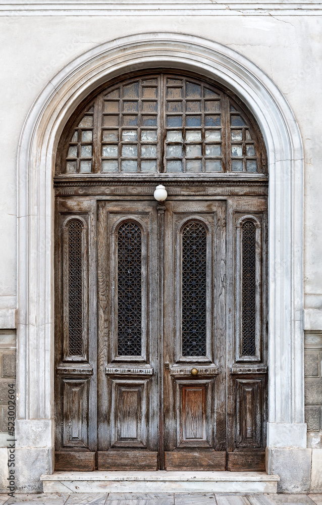 Vintage brown wooden old door in the centre of Athens in Greece.