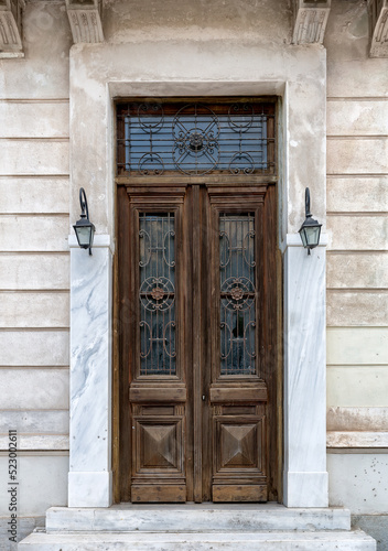 Vintage brown wooden old door in the centre of Athens in Greece. © preto_perola