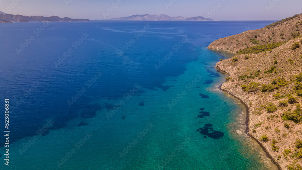 Beautiful seashore. Islands in the distance. Colorful blue sea. The beauty of Turkey. Beautiful rocks and mountains. Sunny clear day. Beautiful water.