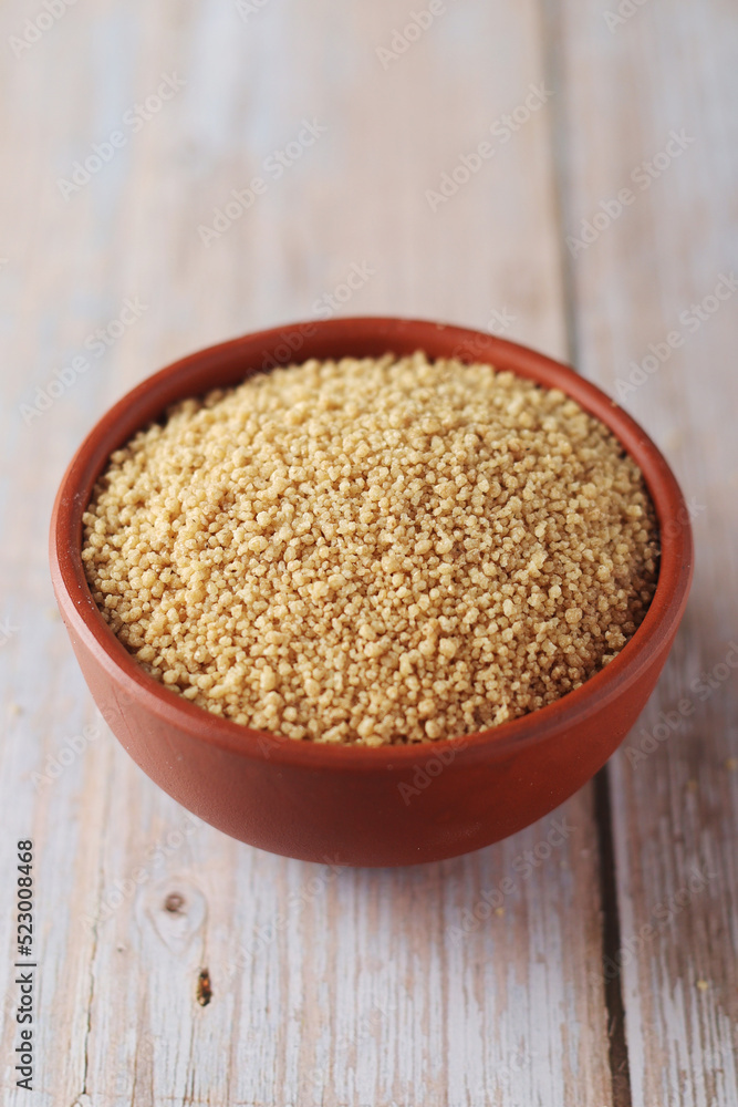 Dry couscous in a small ceramic bowl Dry couscous in a small ceramic bowl