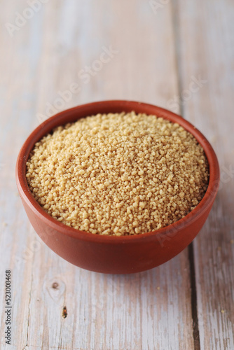 Dry couscous in a small ceramic bowl