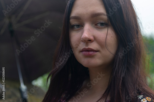 Girl with an umbrella in cloudy weather.