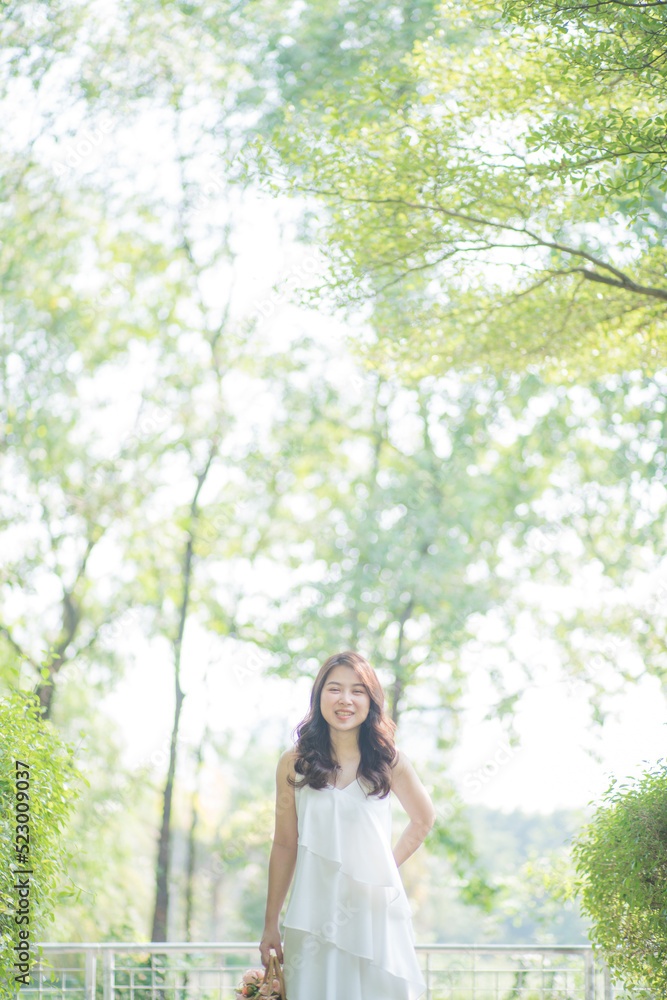 Pretty asian fashion women relax in green city park sunny day Pretty asian fashion women relax in green city park sunny day