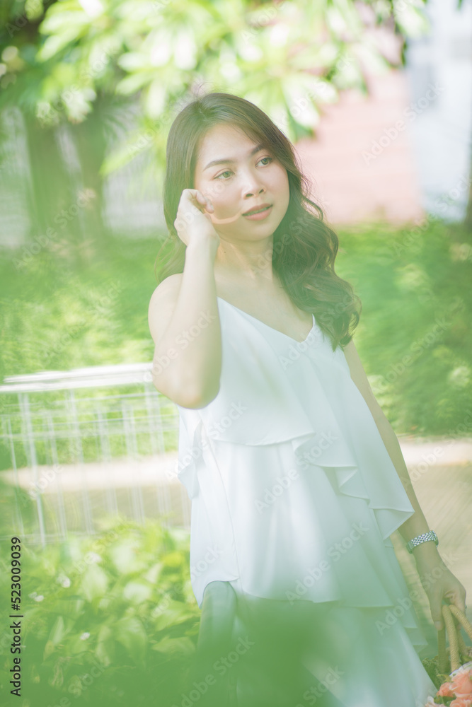 Pretty asian fashion women relax in green city park sunny day Pretty asian fashion women relax in green city park sunny day