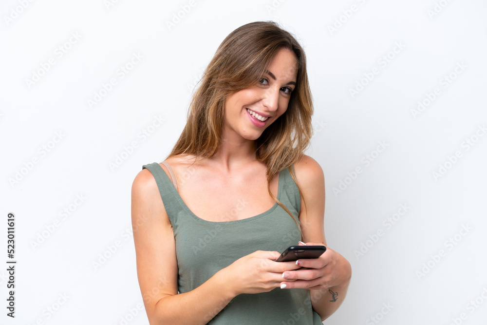 Young caucasian woman isolated on white background sending a message with the mobile Young caucasian woman isolated on white background sending a message with the mobile