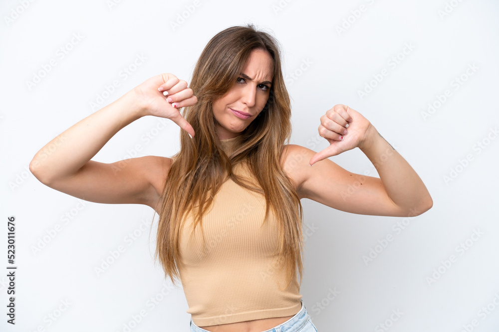Young caucasian woman isolated on white background showing thumb down with two hands Young caucasian woman isolated on white background showing thumb down with two hands