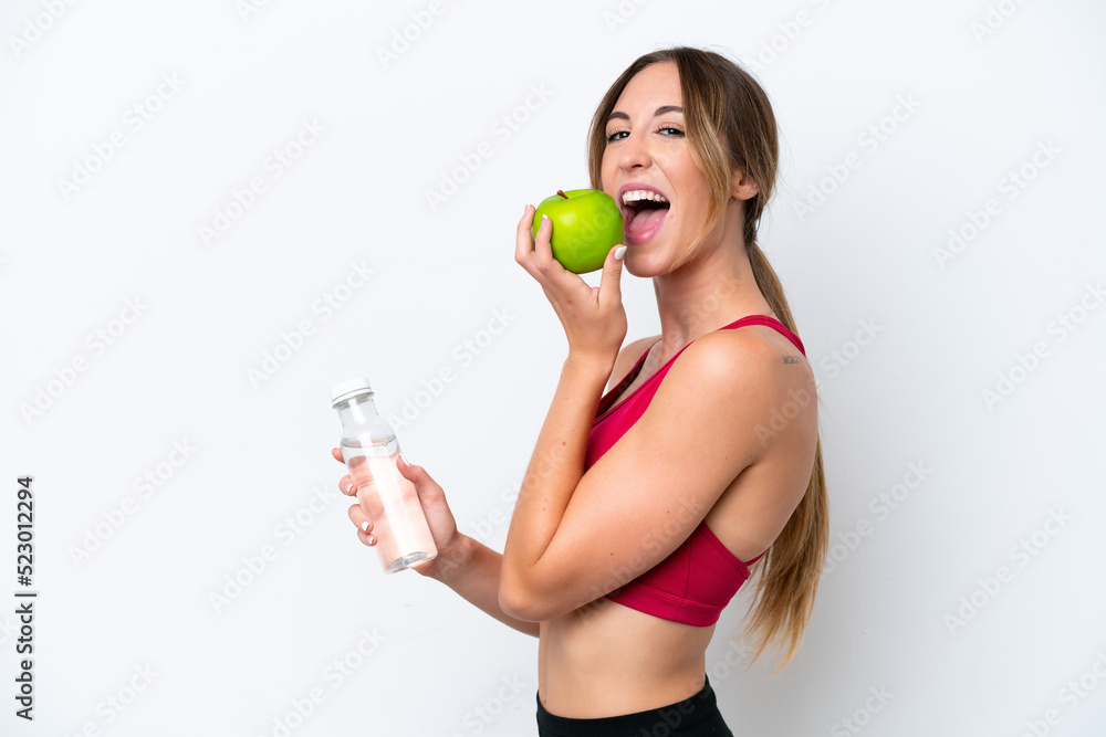 Young caucasian woman isolated on white background with an apple and with a bottle of water Young caucasian woman isolated on white background with an apple and with a bottle of water