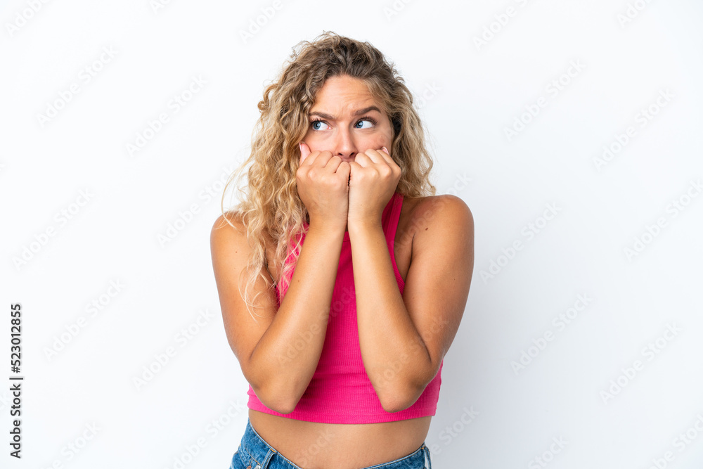 Girl with curly hair isolated on white background nervous and scared putting hands to mouth Girl with curly hair isolated on white background nervous and scared putting hands to mouth