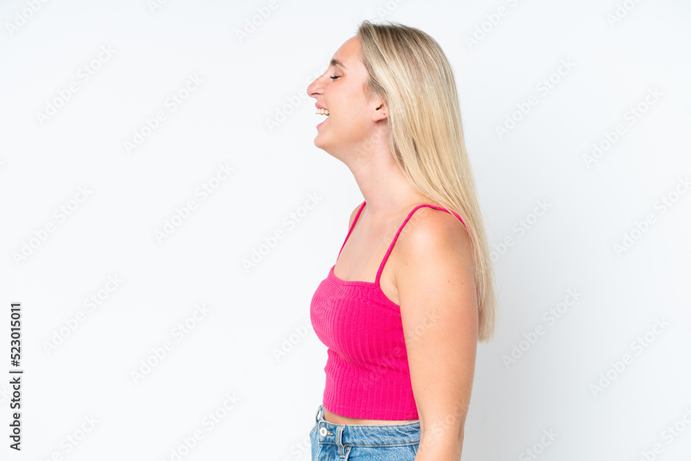 Young caucasian woman isolated on white background laughing in lateral position Young caucasian woman isolated on white background laughing in lateral position