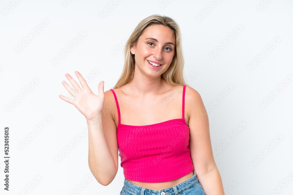 Young caucasian woman isolated on white background saluting with hand with happy expression Young caucasian woman isolated on white background saluting with hand with happy expression