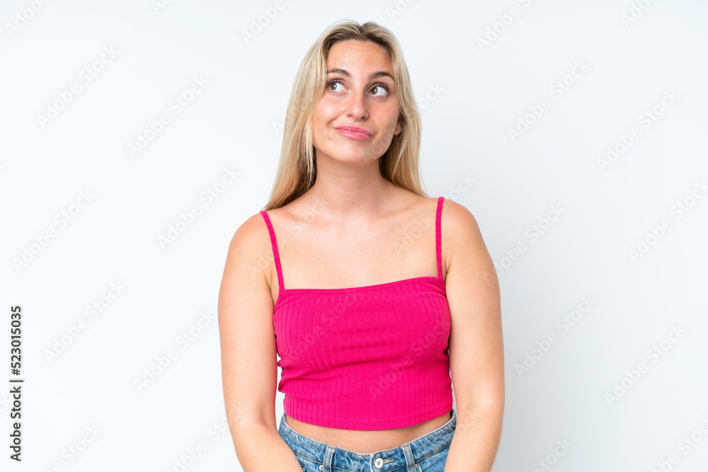 Young caucasian woman isolated on white background having doubts while looking up Young caucasian woman isolated on white background having doubts while looking up
