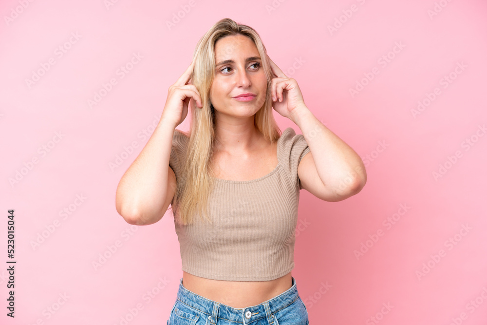 Young caucasian woman isolated on pink background having doubts and thinking Young caucasian woman isolated on pink background having doubts and thinking
