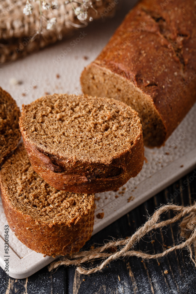 Slices of freshly baked traditional brown bread with crispy crust. Slices of freshly baked traditional brown bread with crispy crust.