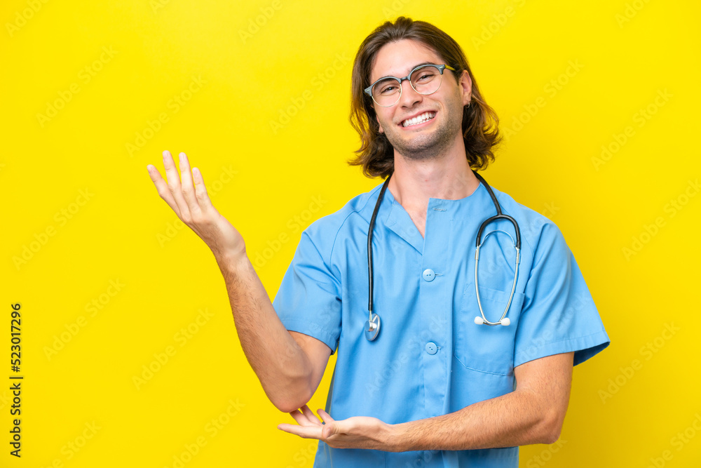 Young surgeon caucasian man isolated on yellow background extending hands to the side for inviting to come Young surgeon caucasian man isolated on yellow background extending hands to the side for inviting to come
