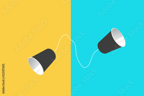 Tin can phone on yellow and blue paper backgrounds. concept of direct business