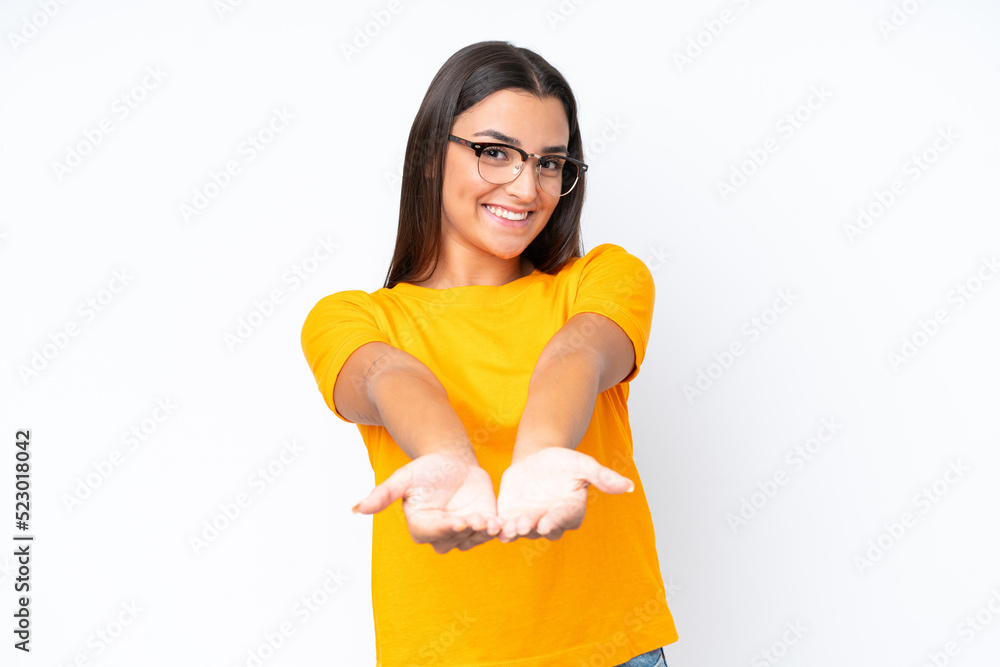 Young caucasian woman isolated on white background holding copyspace imaginary on the palm to insert an ad Young caucasian woman isolated on white background holding copyspace imaginary on the palm to insert an ad