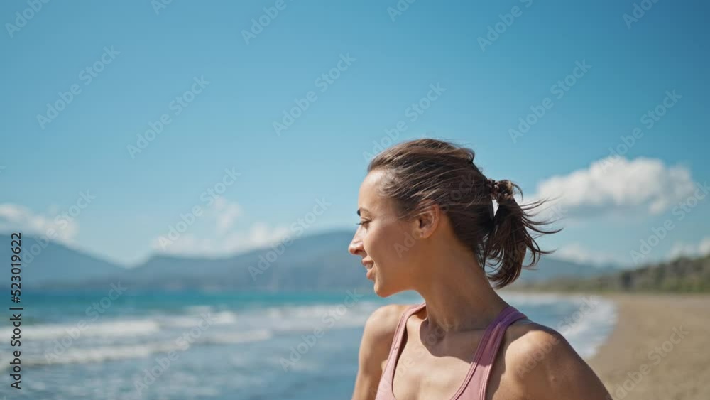 young active sporty athlete smiling woman is taking a break after making running and jogging workout on sea sandy beach with seascape at morning. go everywhere, active lifestyle concept young active sporty athlete smiling woman is taking a break after making running and jogging workout on sea sandy beach with seascape at morning. go everywhere, active lifestyle concept