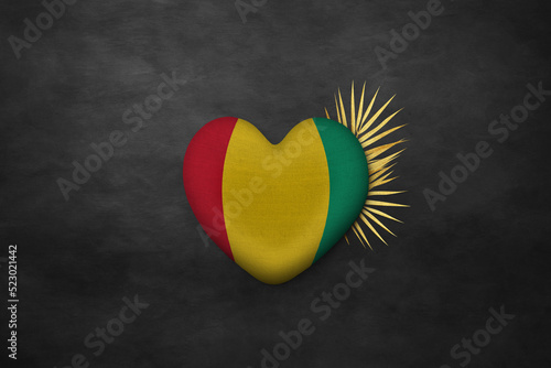 Textile heart in colors of national flag. Photography and marketing digital backdrop. Guinea © Julia