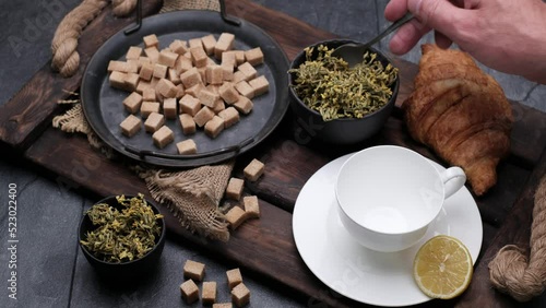 Tea and brown sugar. Close-up 4k video shooting, dark background.