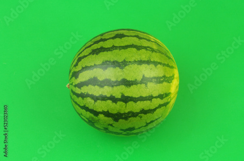 Watermelon on green background close up.