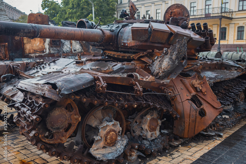 Destroyed Russian tank in the rain. Rusty broken military equipment in the rain