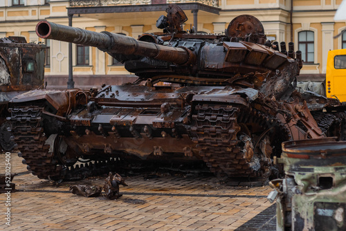 Destroyed Russian tank in the rain. Rusty broken military equipment in the rain